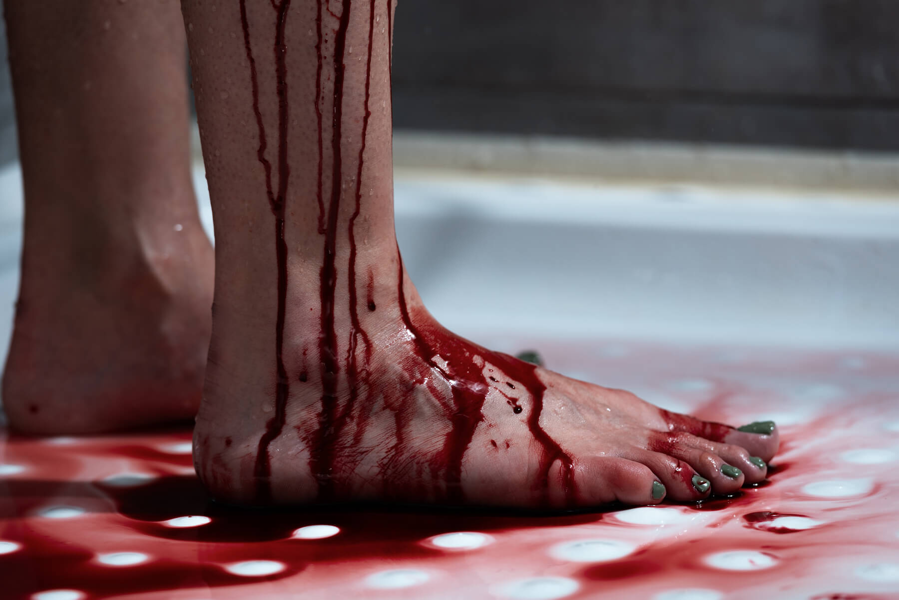 cropped view of barefoot bleeding woman in bathroo 2023 11 27 05 03 45 utc.jpg