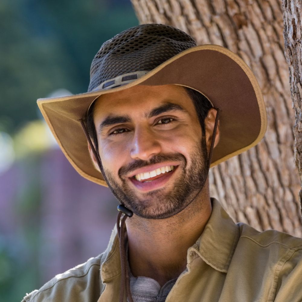 smiling man standing with arms crossed near tree t d8p8b96 1 1.jpg